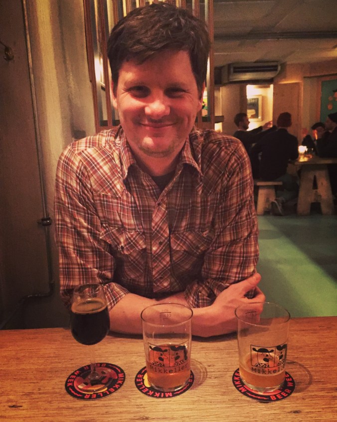 man in bar with three glasses in front of him